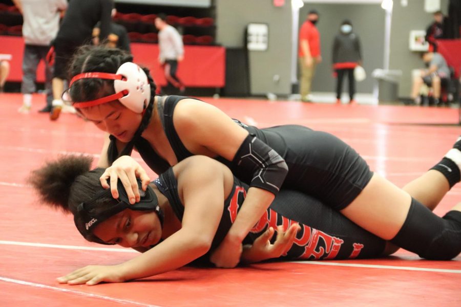 Coppell junior Kylie Fowler competes in the annual Santa Slam Meet at the Coppell High School Arena. The Coppell girls wrestling team placed second in the UIL Region II Championships on April 6 and will compete in Houston tomorrow.