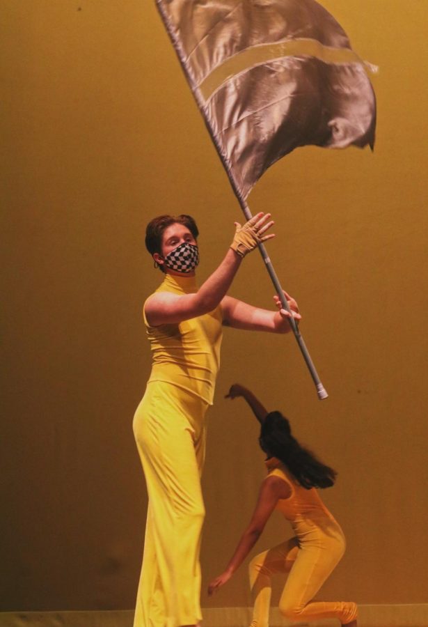 New Tech High @ Coppell senior Parker Crane performs a rifle and flag routine for a Winter Guard International competition at the CHS Auditorium on March 10. Crane joined color guard the second semester of his senior year and is the only male on the team.