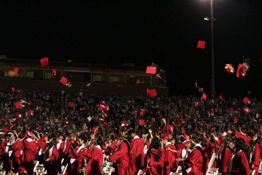 Coppell High School graduating class of 2021 participates in the traditional cap toss at Buddy Echols Field on May 28. CHS held its graduation ceremony at Buddy Echols Field on May 28. Photo by Angelina Liu