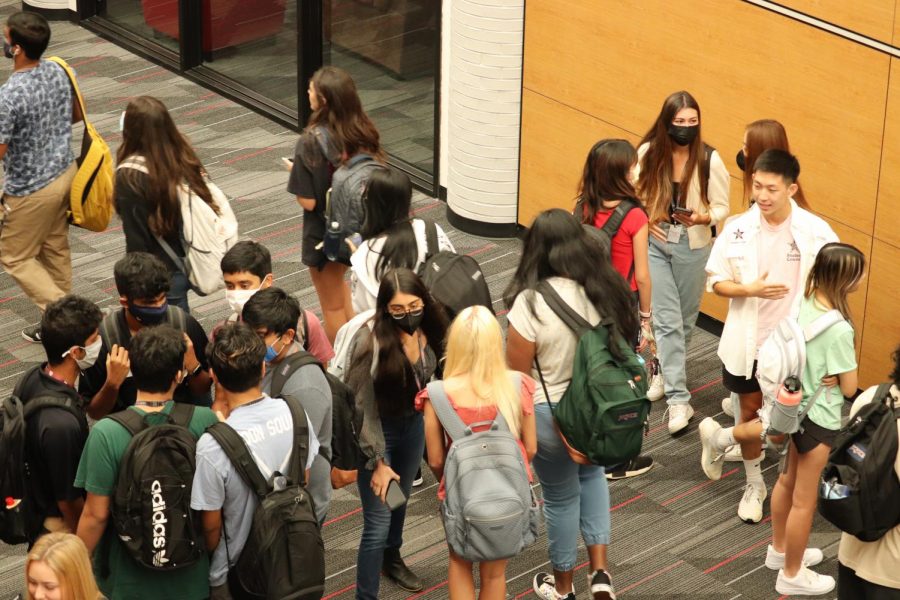 Coppell High School students greet each other before first period on the first day of school on Tuesday. All CHS students are on campus for the first time since March 2020.