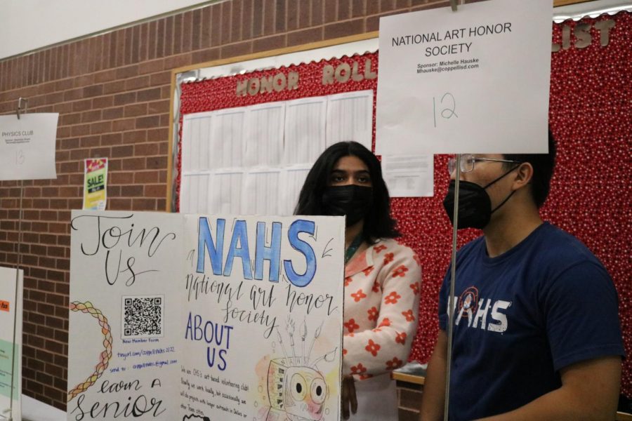Coppell High School senior Amolika Kondapolli and junior Jeffrey Wang provide information on the National Art Honor Society at the Club Expo during lunch on Friday. The Club Expo was held during all lunches on Friday so that students can explore different school clubs. Photo by Sannidhi Arimanda
