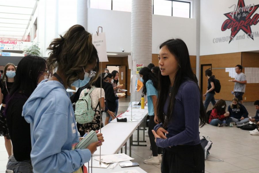 Coppell High School senior Grace Kim provides information to sophomores Minseo Kim and Anaya Dekhne about the Korean Culture Club at the Club Expo during lunch on Friday. The Club Expo was held during all lunches so that students could explore different clubs. Photo by Sannidhi Arimanda
