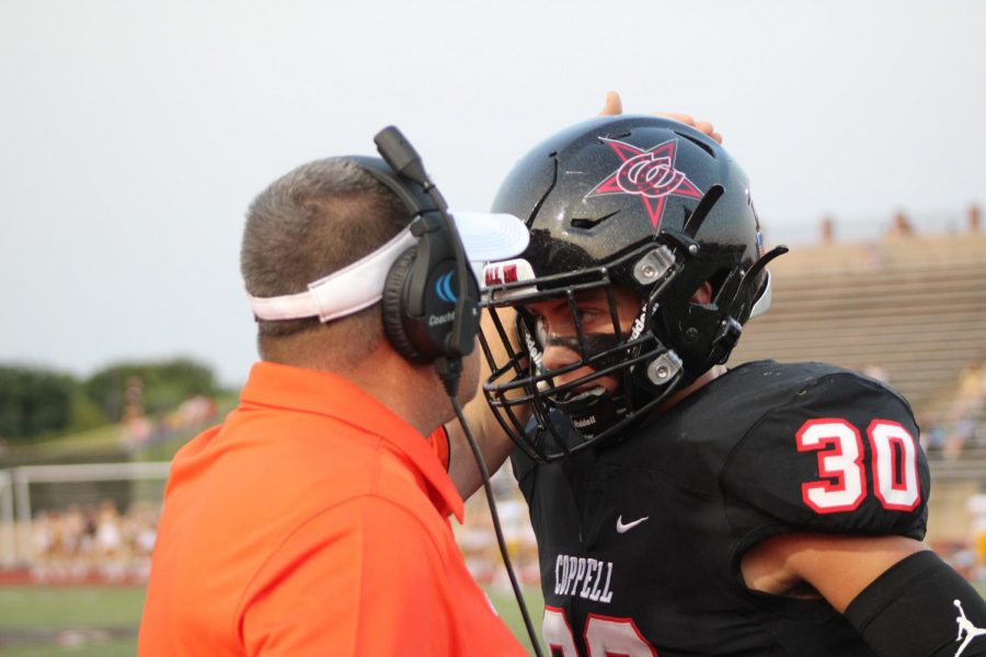 Coppell safeties coach Karl Pointer coaches Coppell freshman safety Weston Polk on defensive scheme against Highland Park on Sept. 19 at Buddy Echols Field. Polk decided, at 10 years old, that he would forgo baseball and has become a cornerstone in the Cowboys’ defense since promotion to varsity.