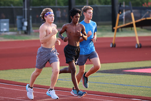 Coppell juniors Andrew Mullen, Karthi Partipan and Samuel Martinson run during cross country practice before school at Buddy Echols Field on Thursday. Mullen started running cross country in seventh grade and now runs on the varsity team.