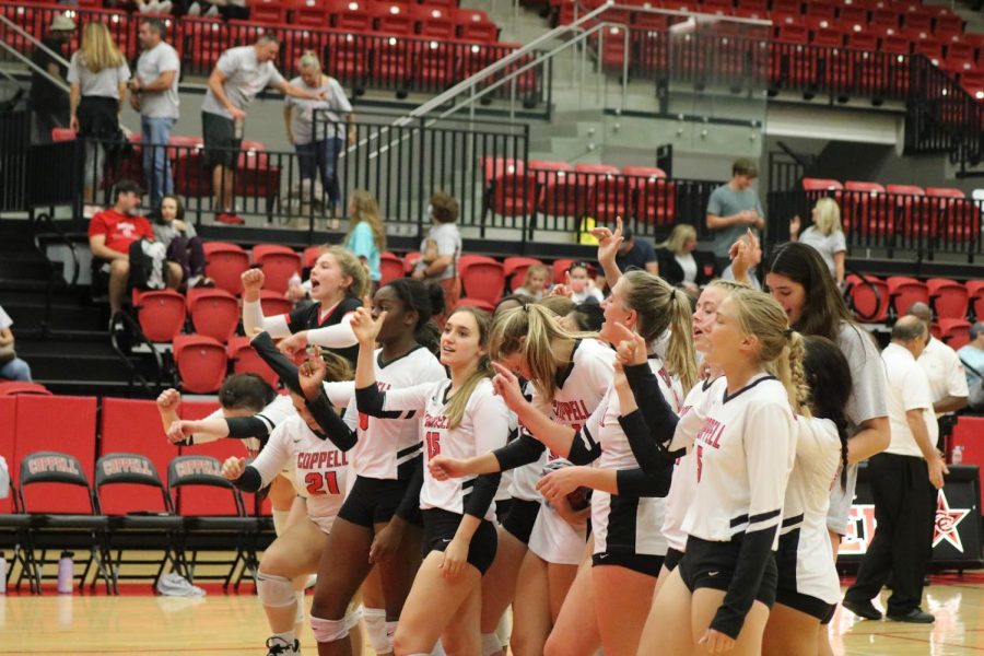 The Coppell volleyball team celebrates winning its match at the CHS Arena on Oct. 12. Coppell volleyball won against Plano East, 3-0 (25-23, 25-22, 25-13).  Photo by Shrayes Gunna