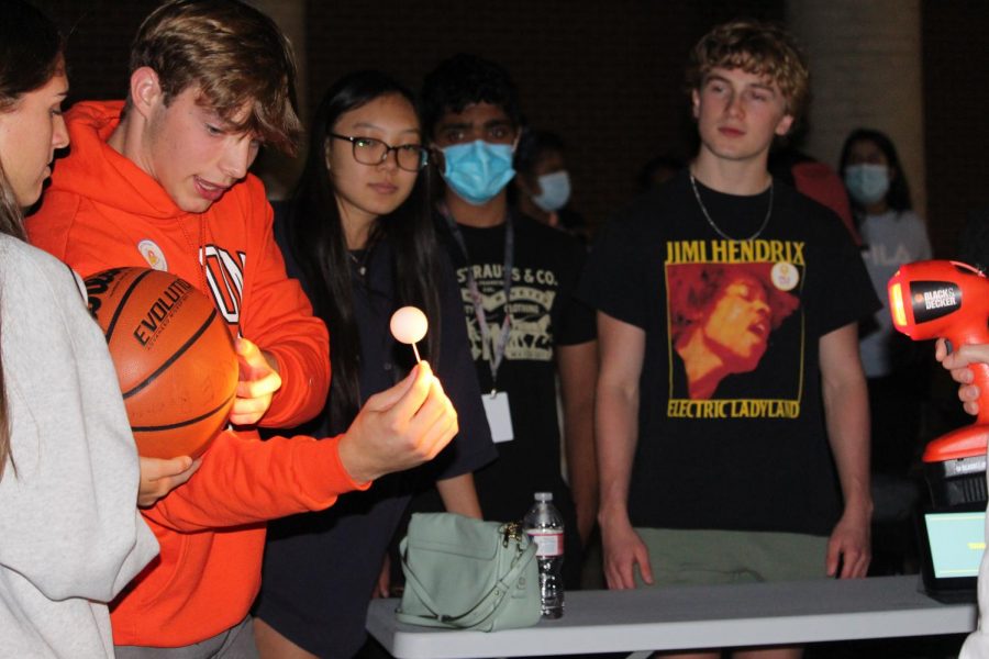 Coppell High School seniors Jake Roemer, Grace Kim, Anirudh Kumbum and Matthew Narez demonstrate moon phases with their model  at the annual fall star party at Coppell High School on Tuesday Oct. 19. CHS astronomy teacher Angela Barnes hosted the annual fall star party at CHS for students to display what they have learned this year. 
