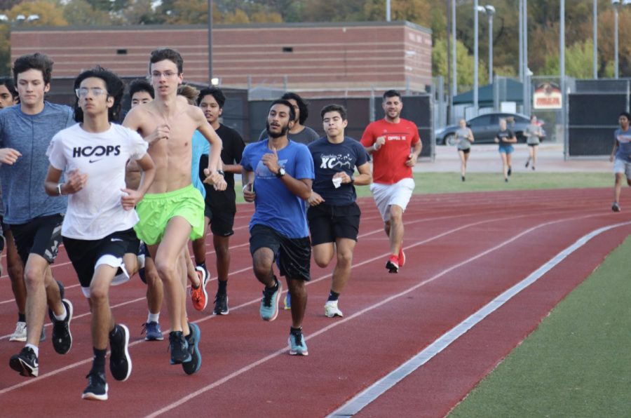 Coppell+cross+country+warms+up+with+a+one+mile+jog+on+Tuesday+at+Buddy+Echols+field.+Coppell+High+School+junior+Tahir+Ali+%28center%29+is+returning+from+an+injury+and+perseveres+to+improve+every+morning.+