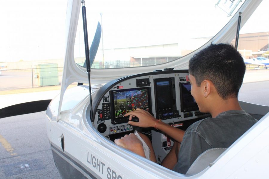 Coppell High School junior Adi Patel checks the control panel of the Czech Sport Cruiser N919TM aircraft at Thrust Flight flight school on Oct. 23 at Addison Airport. Patel is obtaining his pilot’s license and wants to join the U.S. Air Force.