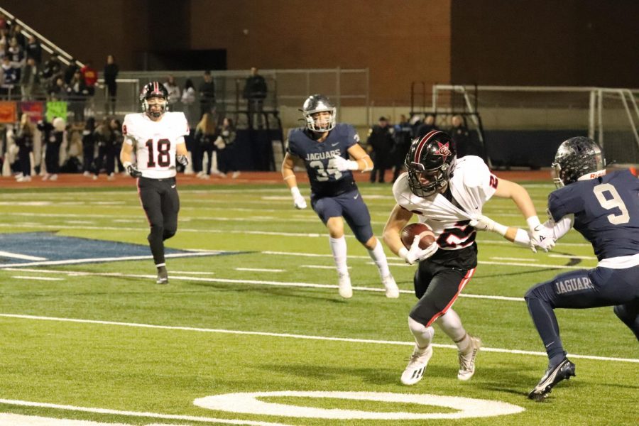 Coppell junior wide receiver Zack Darkoch avoids being tackled by Flower Mound senior cornerback Caleb Green last night at Neil E. Wilson Stadium. The Cowboys fell to the Jaguars, 45-21.