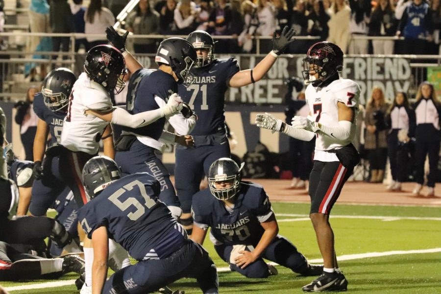 Flower Mound senior quarterback Nick Evers rushes for a touchdown as Coppell freshman free safety Weston Polk attempts to tackle him in the endzone on Friday at the Neil E. Wilson Stadium. The Cowboys fell to the Jaguars, 45-21, ending their season. Photo by Olivia Short.