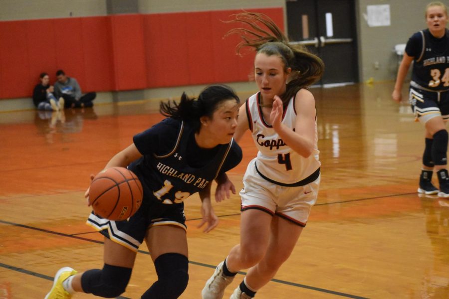 Coppell junior guard Alyssa Potter defends Highland Park junior point guard Vivian Jin on Friday in the Coppell Large Gym. The Cowgirls beat the Scots, 41-37.