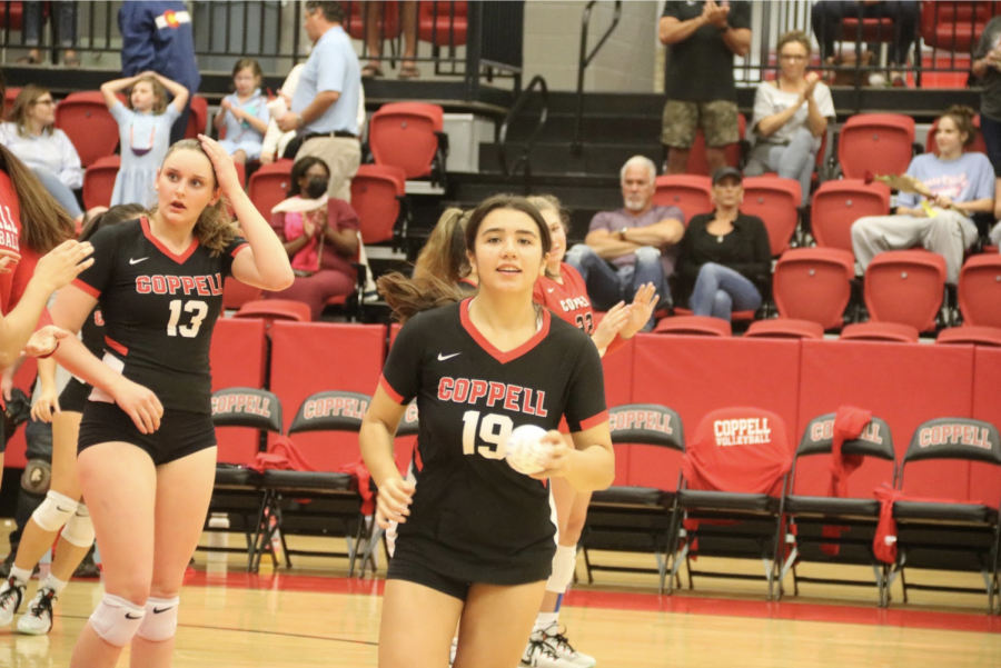 Coppell senior defensive specialist Sude Item warms up before the match against Plano West on Senior Night on Oct. 26 in the CHS Arena. Item has competitively played a variety of sports including gymnastics, volleyball and soccer. Photo by Tracy Tran