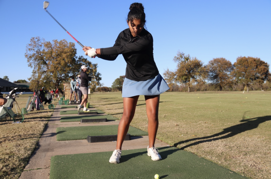 Coppell golf freshman Navmi Srithaj swings at the driving range at Riverchase Golf Club on Thursday. Srithaj balances playing golf on the JV golf team alongside playing the flute in the JV marching band. Photo by Olivia Cooper