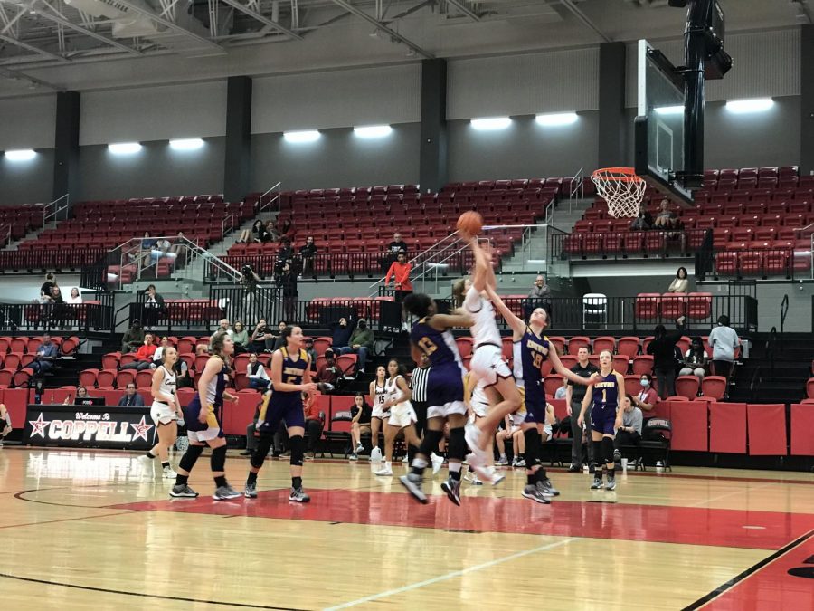 Coppell junior guard Jules LaMendola scores against Edgewood on Tuesday at CHS Arena. The Cowgirls beat the Bulldogs, 66-57.