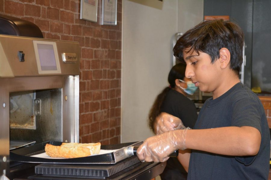 CHS9 student Om Patel prepares a Subway sandwich while on the job in Lewisville on Dec. 4. Patel runs a Subway with the help of his mother while simultaneously balancing school and other activities. 