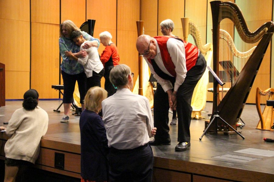 Harpists Grace Johnson and Stan Guy interact with concert attendees and answer questions about the concert post-performance. The Coppell Arts Center hosted the HarpEssence Holiday, sponsored by the Cozby Library and Community Commons, on Dec. 5. 