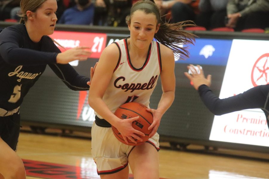 Coppell junior guard Alyssa Potter drives against Flower Mound during the second quarter at CHS Arena on Friday. The Cowgirls beat the Jaguars, 49-40. 