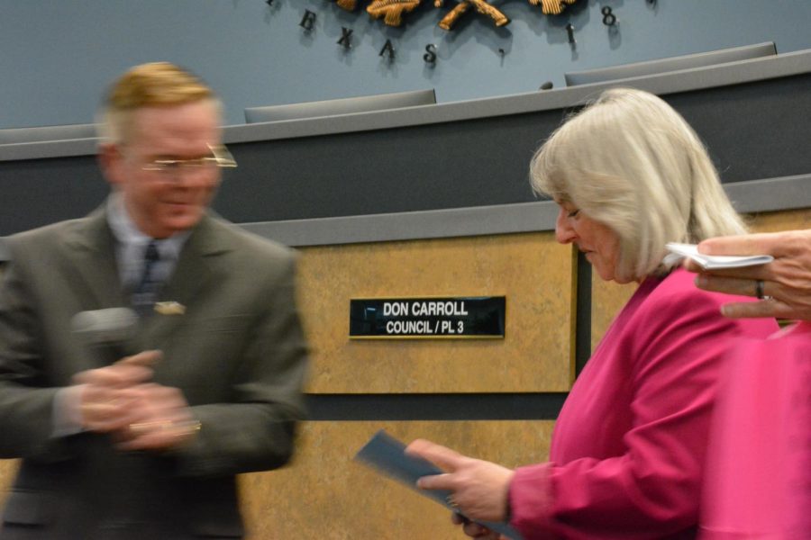 Former Coppell city financial manager Jennifer Miller accepts her parting gifts from Mayor Wes Mays at the Coppell City Hall on Tuesday. In remembrance of her contributions to the city, Jan. 25, 2022 is now recognized as Jennifer Miller Appreciation Day.