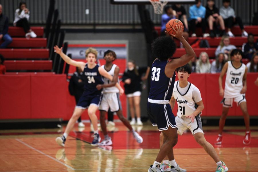 Coppell sophomore shooting guard Alex Tung defends Flower Mound junior Druv Robinson in CHS arena on Friday. The Cowboys lost to the Jaguars, 31-26. 