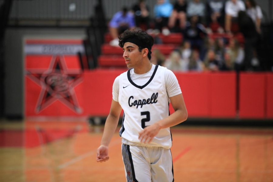 Coppell senior point guard Devank Rane walks down the court after a timeout in CHS Arena last night. The Cowboys lost to the Jaguars, 31-26. 