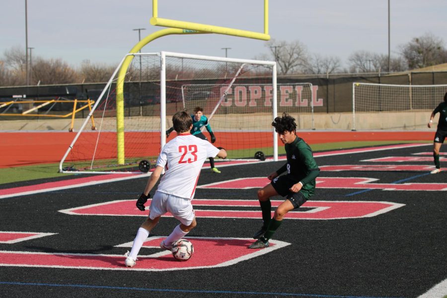 Coppell+High+School+junior+forward+Alfred+Fairchild+looks+for+an+opening+against+Reagan+on+Friday+in+the+North+Texas+Elite+Showcase.+Reagan+defeated+the+Cowboys%2C+2-1.+