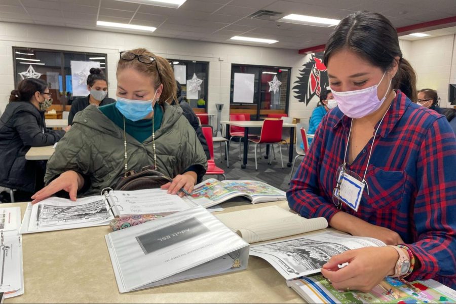 Adult English as a Second Language students Adriana Pardo and Vivian Oropeza review their class worksheet about identifying different types of buildings in a city. Coppell Middle School East hosts the ESL classes every Tuesday at the CMS East Library.