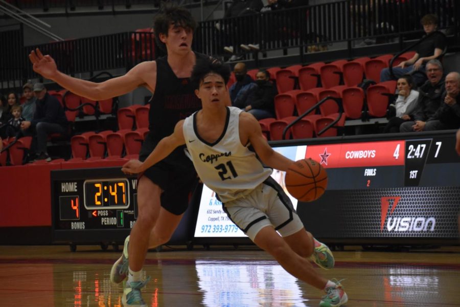 Coppell+sophomore+point+guard+Alex+Tung+drives+to+the+basket+against+Flower+Mound+Marcus+in+CHS+Arena.+The+Cowboys+were+defeated%2C+60-49%2C+on+Tuesday+night.%0A