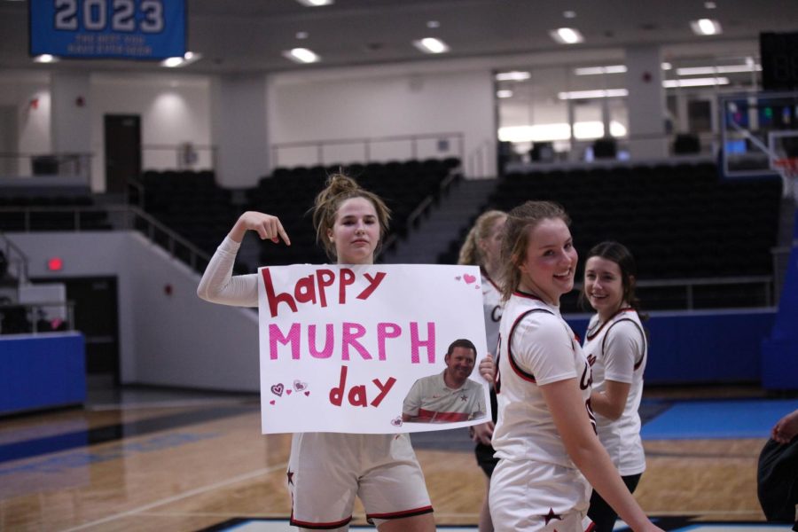 Coppell junior guard Jules Lamendola holds a sign celebrating Murph Day, which is Coppell coach Ryan Murphy’s birthday on Monday. The Cowgirls went into halftime leading, 34-14, and ended the night with a win against the Eagles, 63-39, in the Class 6A Region I bi-district playoffs. 