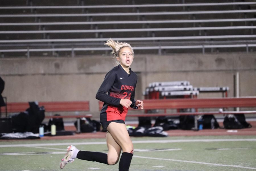 Coppell freshman Monica Morales runs after the ball against Plano West at Buddy Echols Field on Jan. 28. Morales is one of six freshmen on the girls varsity soccer team at CHS. Photo by Aliza Abidi