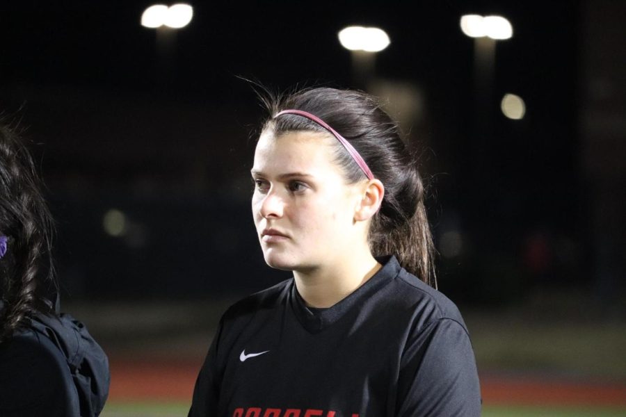 Coppell senior Claire Yaney listens to soccer coach Fleur Benatar-Whitten after the Cowgirls match against Plano West at Buddy Echols Field on Friday. Yaney is a captain for the Cowgirls, in addition to being a member of student council and a Coppell High School Red Jacket.