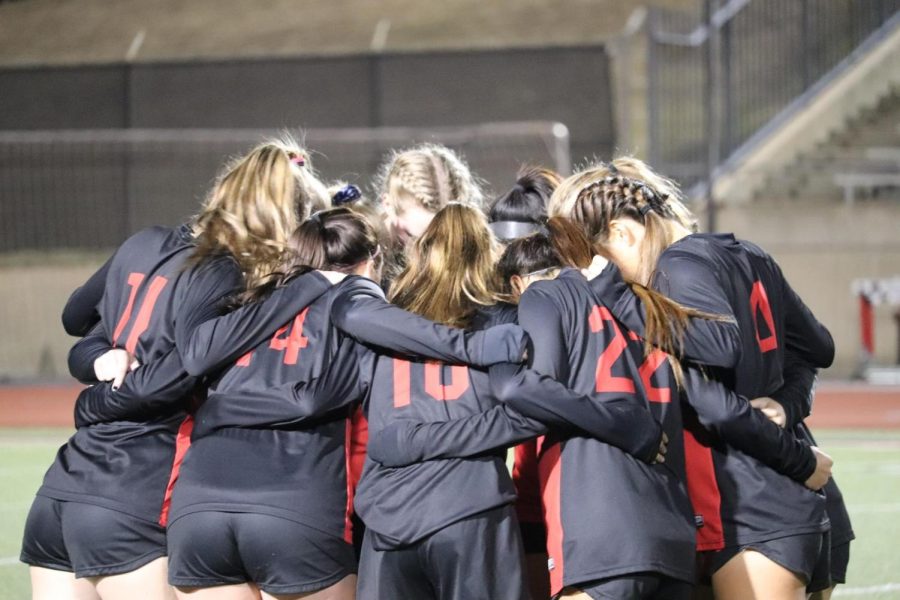 Coppell girls varsity soccer team huddles prior to its match against Plano West at Buddy Echols Field on Friday. The Cowgirls lost to the Wolves, 3-0. 