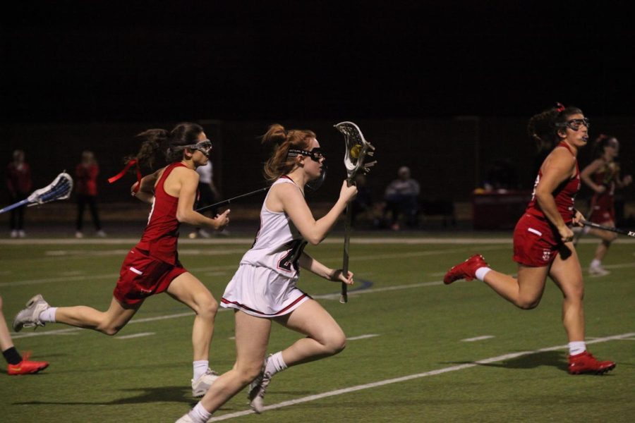 Coppell senior Anna Kate Terry shoots against Dallas Ursuline Academy on Thursday at CMS North Field. Coppell lost to Ursuline, 9-7. Photo by Olivia Short.