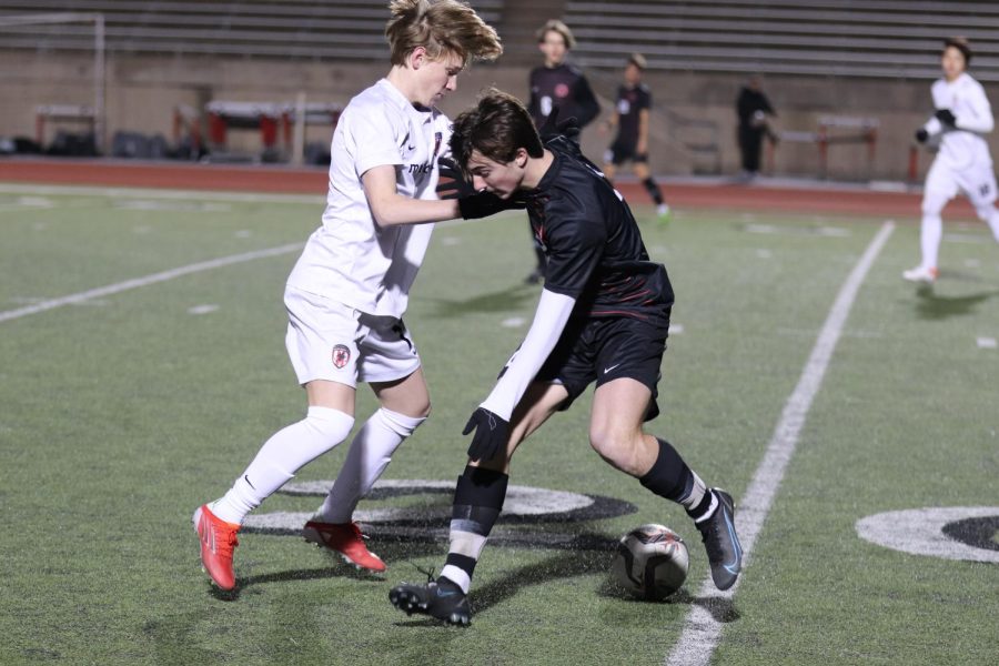 Coppell junior midfielder Ryder Brock defends against Flower Mound Marcus at Buddy Echols Field on Friday. The Cowboys defeated the Marauders, 3-0.