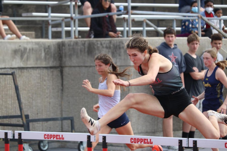 Coppell junior Sky Schuller lunges in the 100-meter hurdle at Buddy Echols Field on Saturday at the Coppell Relays, setting a CHS record at a time of 14.30. The Cowboys placed first at the Coppell Relays while the Cowgirls took second place overall.
