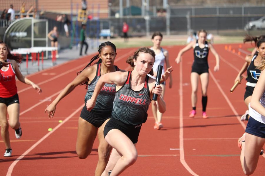 Coppell junior Megan Judd begins her leg of the 4x200-meter relay after receiving the baton from senior D’Aira Green at Buddy Echols Field on March 5 at the Coppell Relays. The District 6-6A Track and Field Meet was hosted at Plano East Senior High School on April 13-14, with the Coppell boys winning first and Cowgirls placing second.