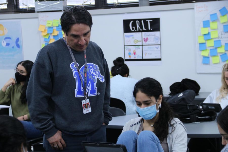 Coppell High School AP Spanish teacher Eligio Mares assists CHS sophomore Roma Jani during his first period on March 9. Mares has been selected as Issue 5 Teacher of the Issue for the 2021-22 school year.