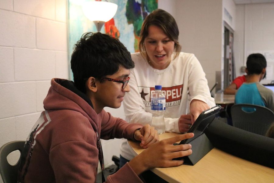 CHS9 AP human geography teacher Annie Fillers helps CHS9 student Ashwath Jagtap with a practice multiple choice question as the students are preparing for the upcoming AP exam. Fillers graduated from the University of North Texas in 2018 and has been teaching at CHS9 since.