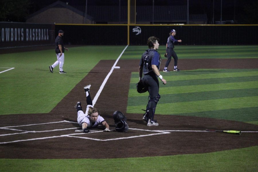 Coppell+junior+courtesy+runner+Matthew+Williams+slides+home+for+the+Cowboys%E2%80%99+game+tying+run+against+Flower+Mound+in+the+bottom+of+the+fourth+inning+last+night+at+Coppell+ISD+Baseball%2FSoftball+Complex.+The+Cowboys+defeated+the+Jaguars%2C+3-2%2C+behind+a+walk-off+single+from+senior+pitcher+Andrew+Nester+to+clinch+the+Co-District+6-6A+Championship.+