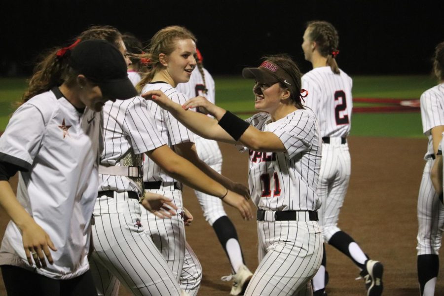 Coppell sophomore shortstop Mallory Moore congratulates her teammates after a win against Plano West at the Coppell ISD Baseball/Softball Complex on Tuesday. The Cowgirls defeated the Wolves, 5-3.