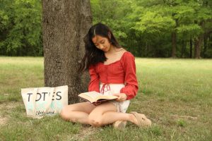 Coppell senior valedictorian Mira Jiang reads one of her favorite books, War and Peace by Leo Tolstoy. Jiang is an novelist, musician and dancer as well as philanthropist.