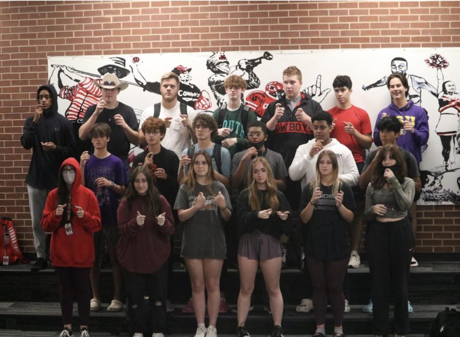 Coppell+High+school+American+Sign+Language+II+class+signs+Christmas+songs+at+the+pit+during+third+period.+Currently%2C+the+district+has+cut+ASL+III+and+IV+but+a+petition+signed+by+the+students+and+possible+solutions+to+bringing+the+classes+back+are+under+review+by+Coppell+ISD+administration.