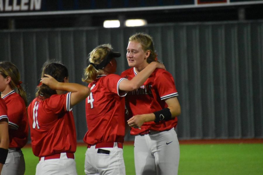 Coppell sophomore utility runner comforts senior pitcher Kat Miller on Friday at Allen. Coppell was defeated by Allen in its home playoff debut, 3-1, and was swept by Allen after losing, 9-4, in Game 2 of the Class 6A Region I bi-district playoff series.