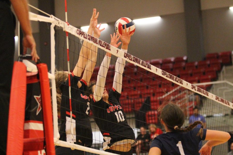 Coppell senior middle hitter Allie Stricker and junior right side hitter Mira Klem block against McKinney Boyd at the CHS Arena on Tuesday. Coppell defeated McKinney Boyd, 25-11, 25-15, 16-25, 25-17. Photo by Olivia Short.