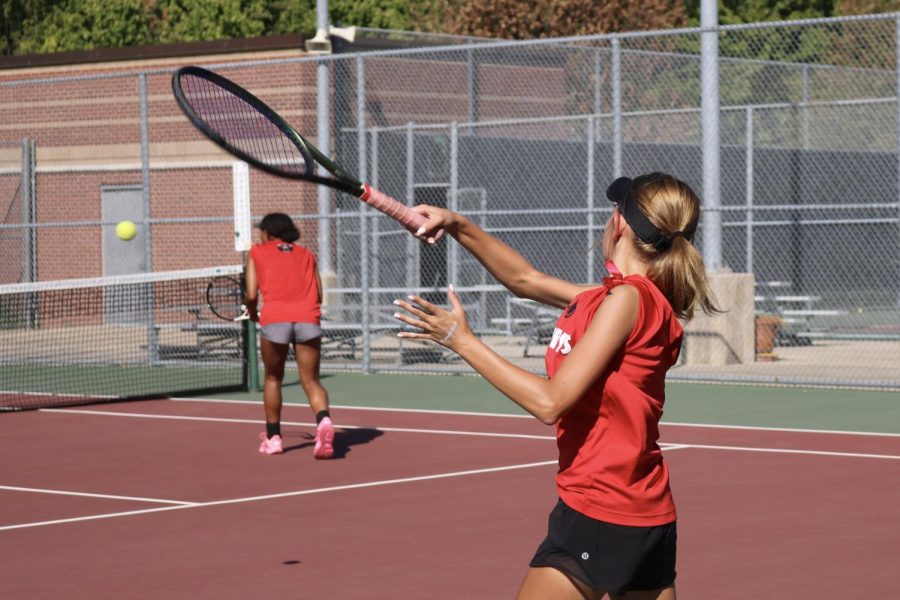 Coppell freshman Lexie Patton serves against Hebron in her doubles match with freshman Gabby Rice on Tuesday at the Coppell Tennis Center. Coppell defeated Hebron, 13-6.