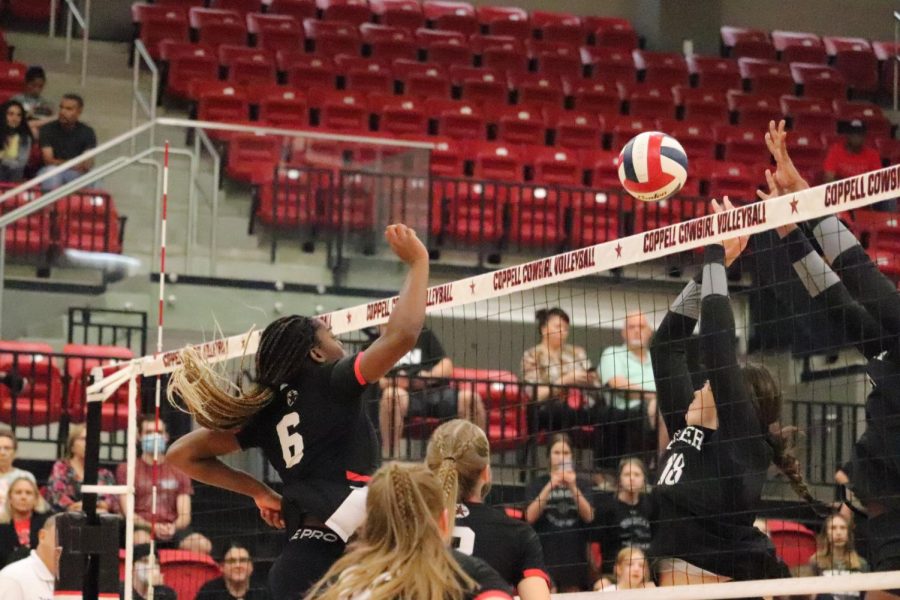Coppell senior middle blocker Ekwe Anwah tips against Denton Guyer at Coppell High School Arena on Aug. 30. The Cowgirls carved out a victory after losing the first set: 16-25, 25-16, 25-23, 25-21.