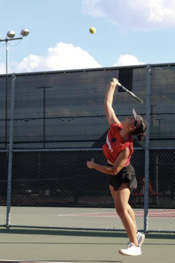 Coppell junior Allyson Keng serves in her doubles match against Hebron on Tuesday at the Coppell Tennis Center. Coppell defeated Hebron, 13-6. 