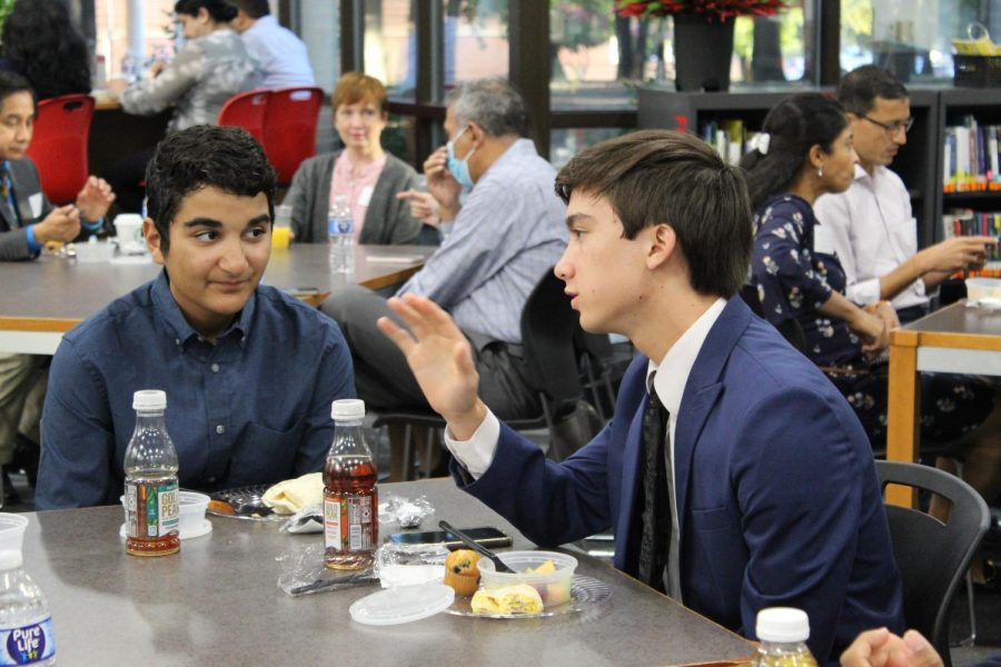Coppell High School seniors Arman Pathan and Ethan Horng converse during the National Merit Semifinalist Recognition breakfast in the CHS Library on Wednesday. Thirty-one CHS seniors were named National Merit Semifinalists and now have the opportunity to earn scholarships and apply to become a National Merit Finalist.  