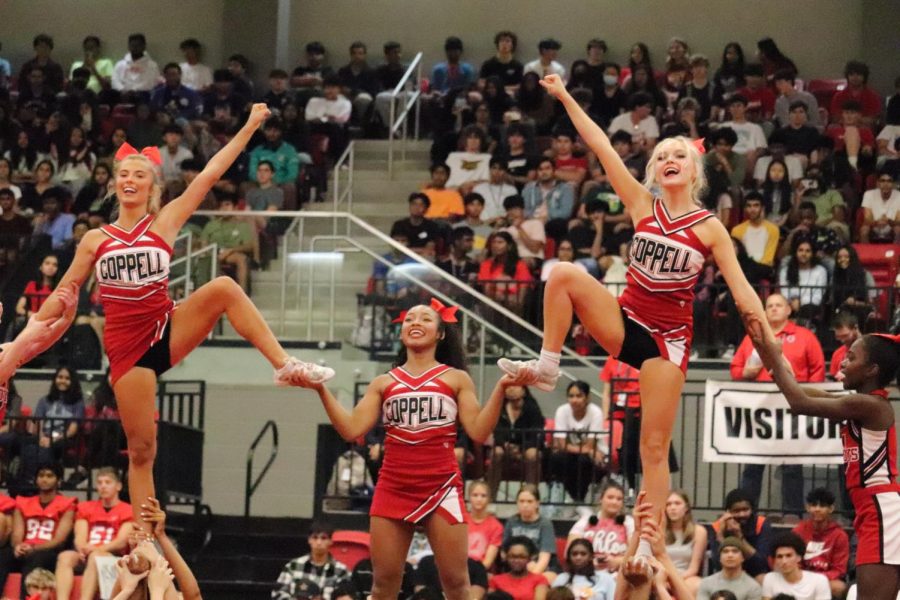 Coppell High School senior cheerleaders Lindsay Rozas, Sydney Benson and Claire Watkins perform in the CHS Arena on Sept. 2. CHS held its first pep rally of the 2022-23 school year, highlighting the school’s various student organizations and celebrating school spirit.