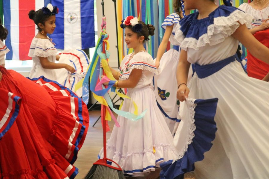 Denton Creek Elementary student Hannah Lingenbrick plays a Spanish game at the Coppell Cozby Library and Community Commons on Sunday. Tex-Latins Inc. presented a program about Latin American folklore and dance in celebration of Hispanic Heritage Month.