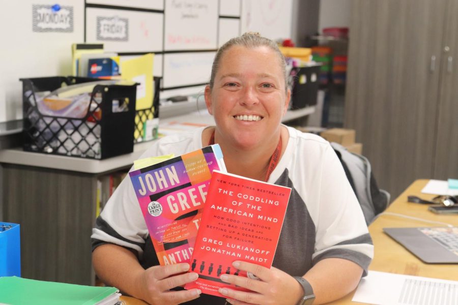 Coppell+High+School+AP+English+Language+and+Composition+teacher+Tracy+Henson+displays+a+summer+reading+book+along+with+other+literature+students+will+be+studying+throughout+the+course+of+the+year.+Henson+has+been+a+teacher+at+CHS+for+20+years+and+has+been+teaching+the+AP+English+3+course+and+grew+up+in+Coppell.